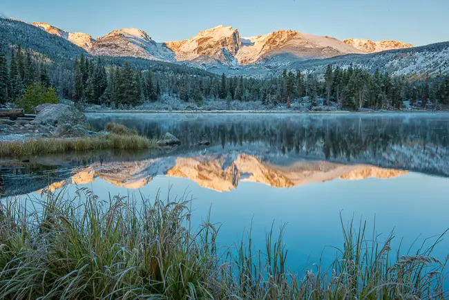Sprague Lake sunrise with fresh snow and refelction in Rocky Mountain National Park